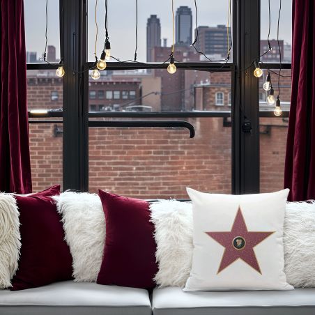 White decorative cushion personalized with first name · Interior decoration idea for cinema lovers